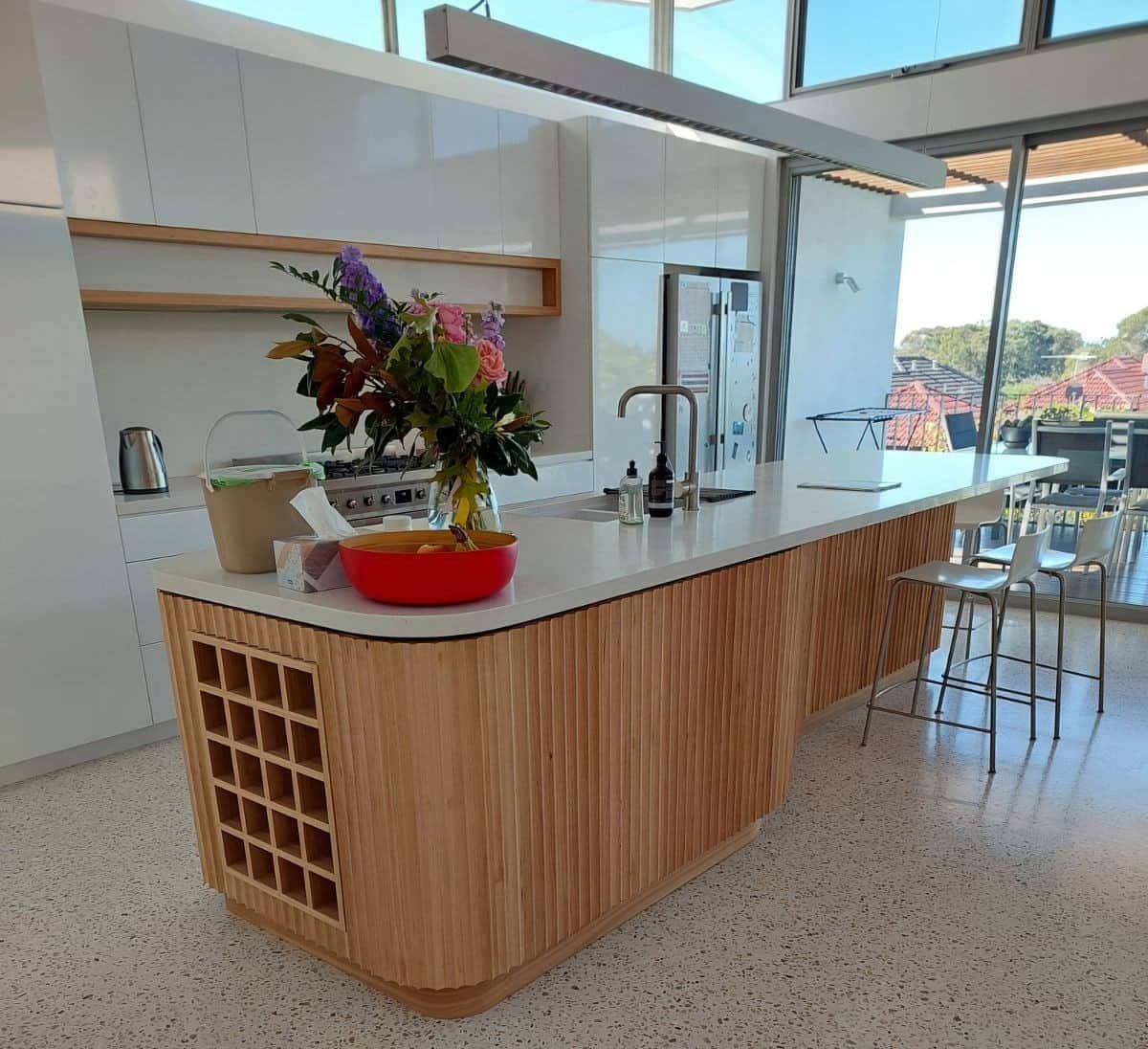 White kitchen with wood lined base