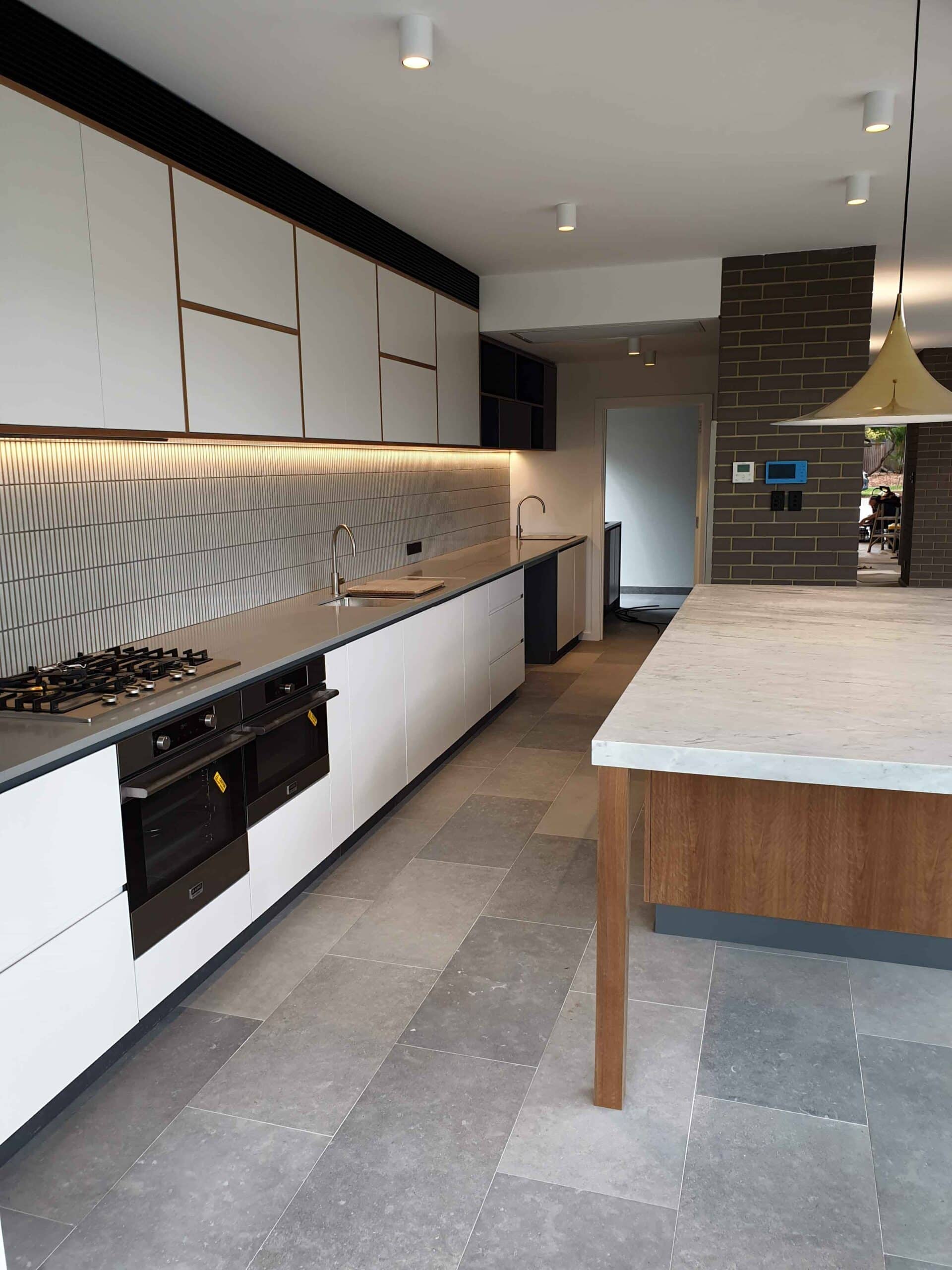 long angle of modern brass lined kitchen