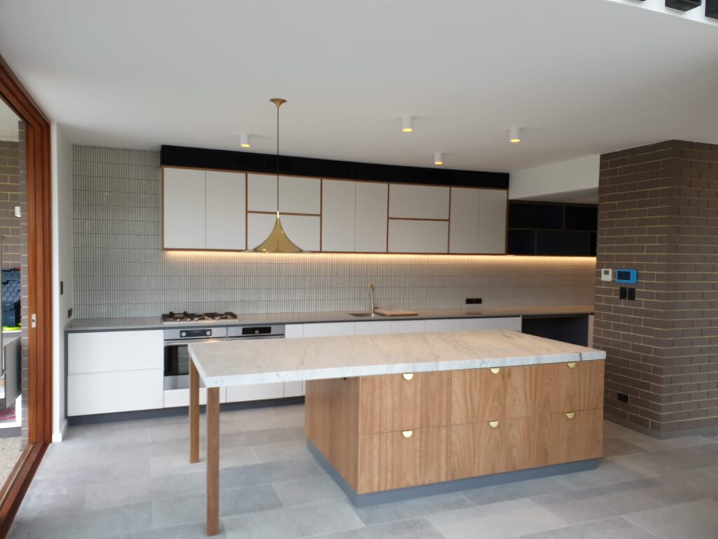 Modern kitchen with brass light fitting by DIY Flat Packs Perth